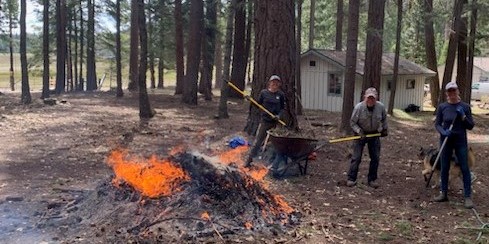 volunteers tend a burn pile at Wherrit property